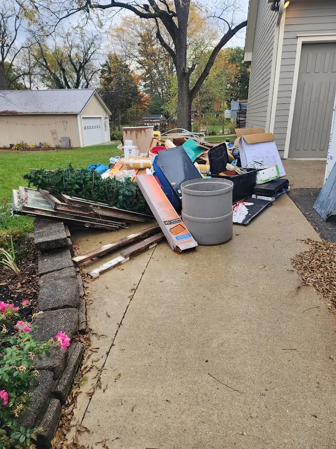 Dumpster being loaded with debris for Estate Cleanout Dumpster Rental in Nipomo